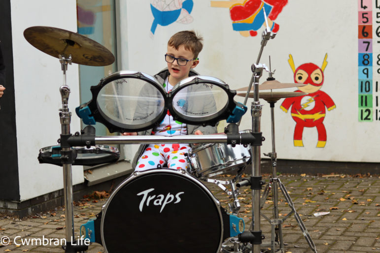 A boy plays the drum