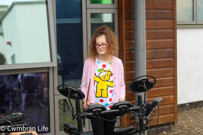 A girl plays the drums