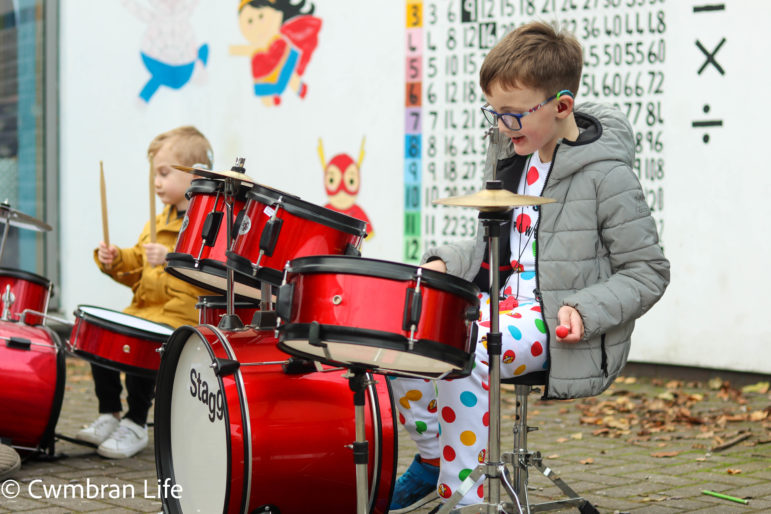 A boy plays the drums