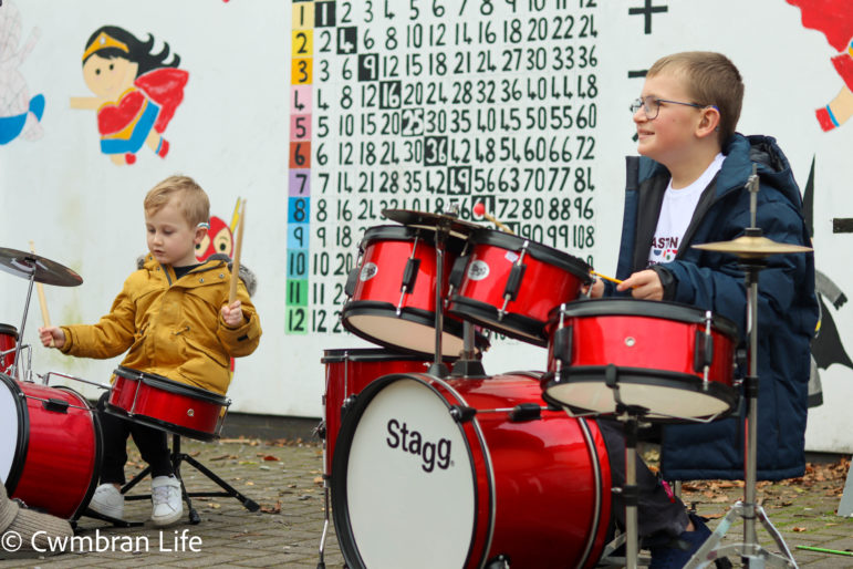 Two boys play the drums