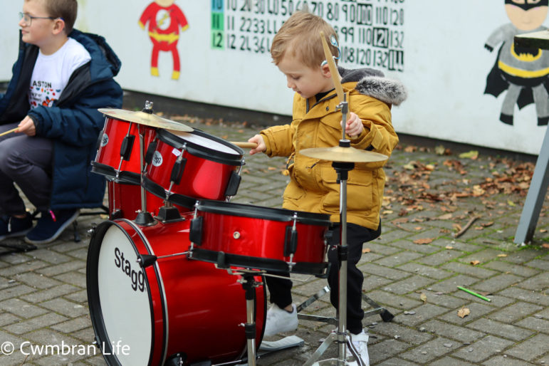 A boy plays the drums