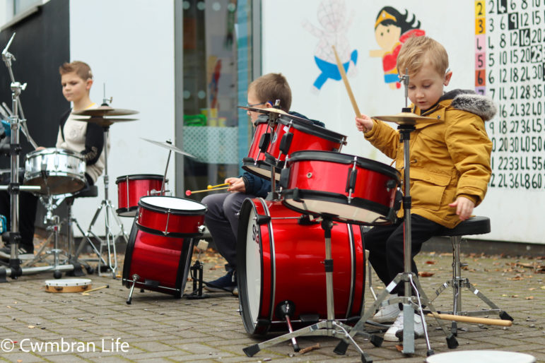 A boy plays the drums