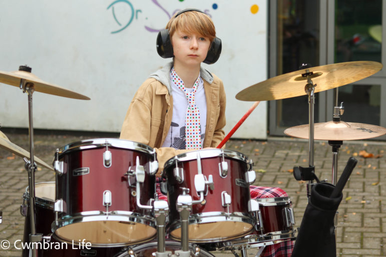 A boy plays the drums