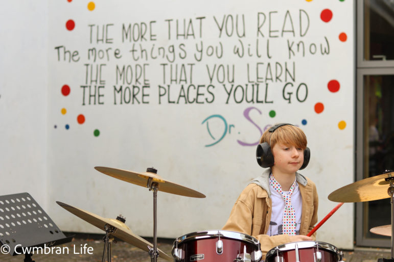 A boy plays the drums