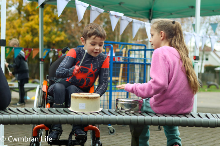 A boy and a girl play the drums