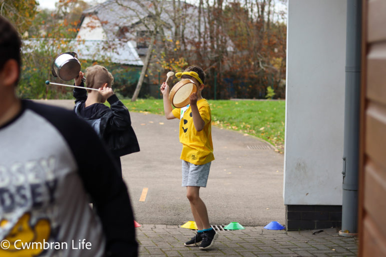 2 boys play with instruments