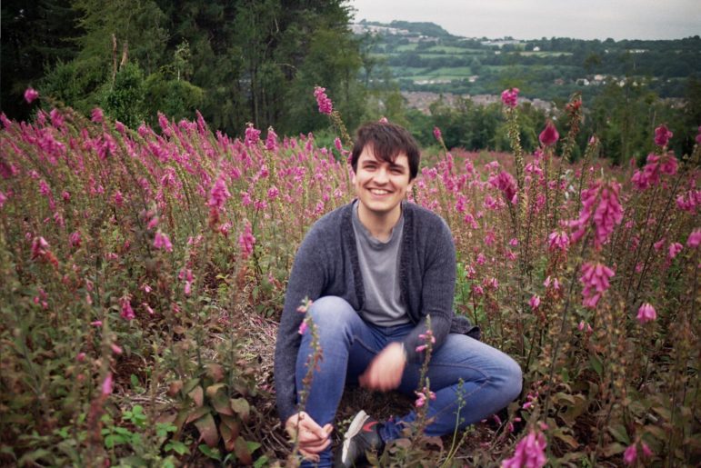 Michael Rees sat in a field of flowers