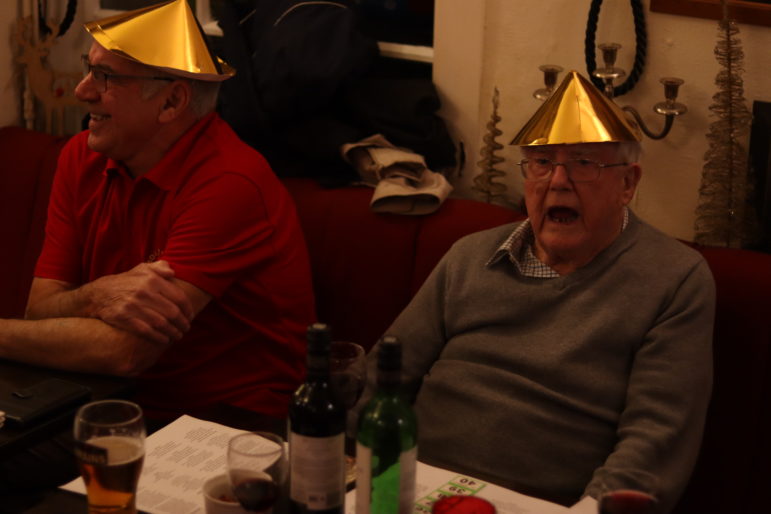 two men in christmas hats