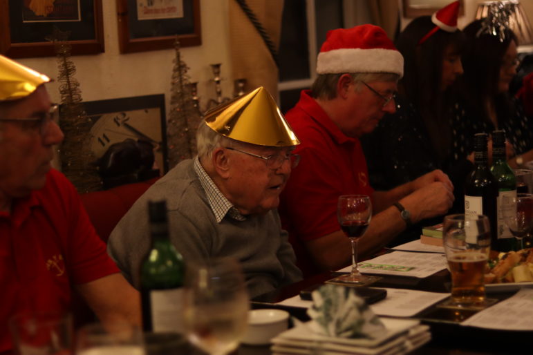 three men in christmas hats