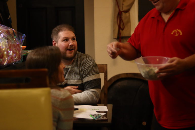 a man holding raffle tickets