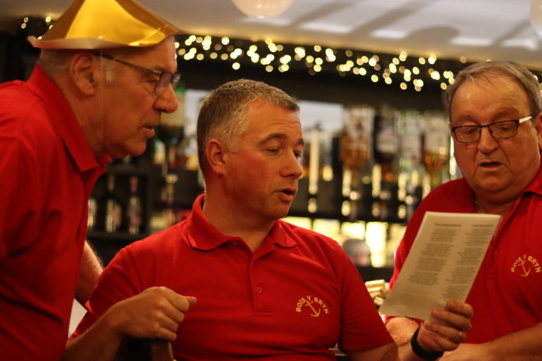 three men singing