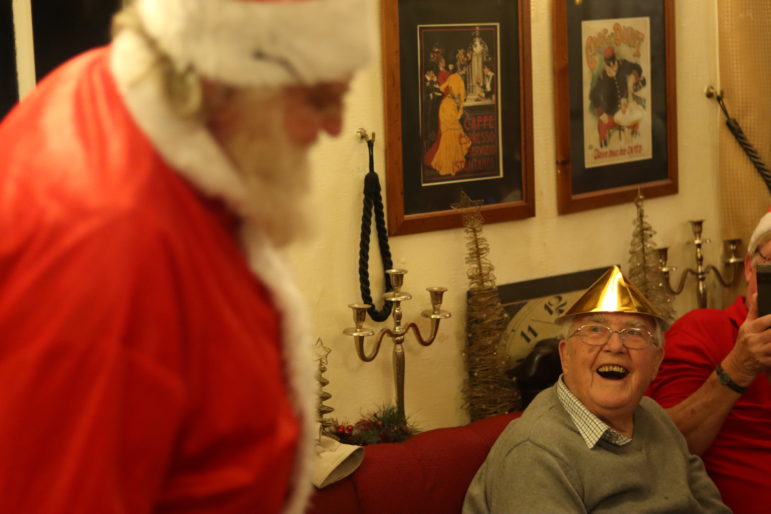 santa and man in christmas hat