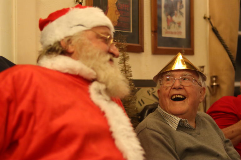 santa and man in christmas hat