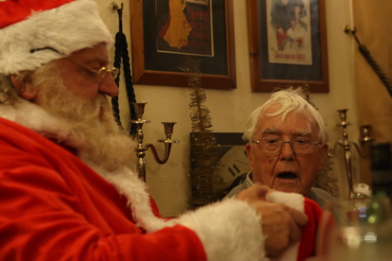 santa and man in christmas hat