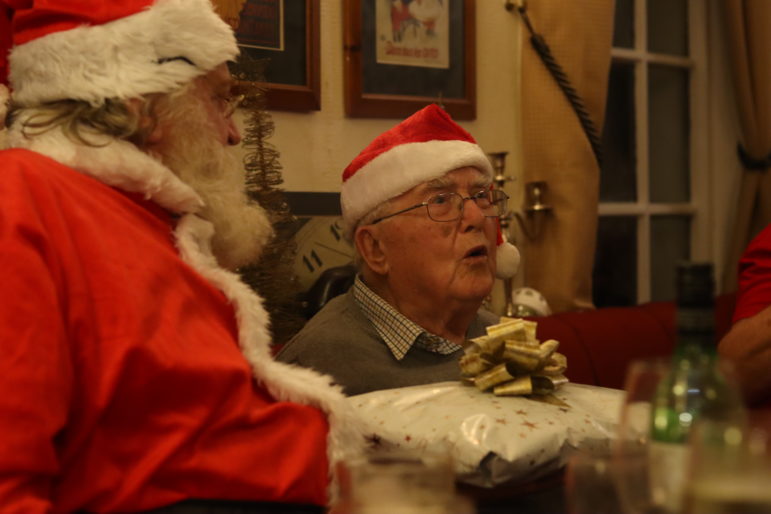 santa and man in christmas hat