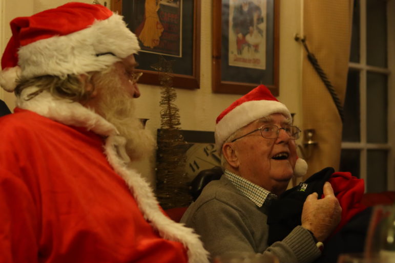 man in santa hat with man dressed as santa