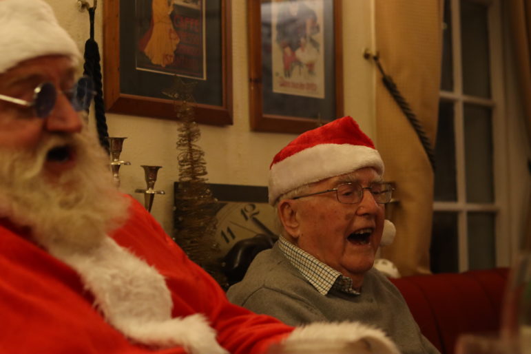 a man laughing next to santa