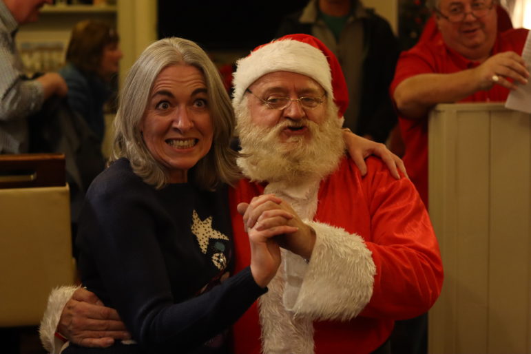 a woman dancing with santa