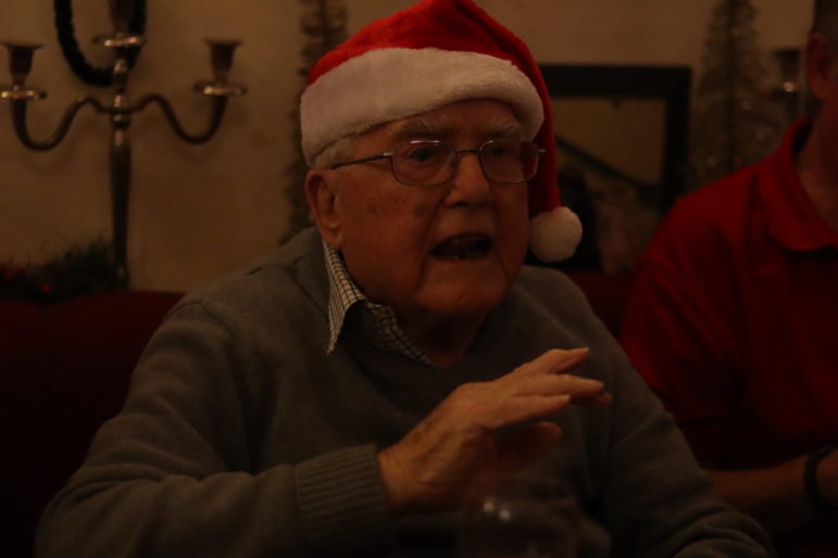 a man in a santa hat singing