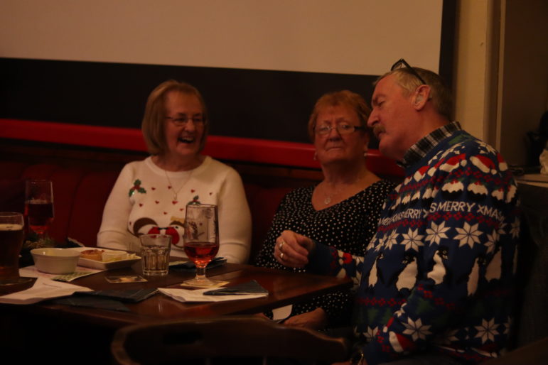 a woman laughing with two people