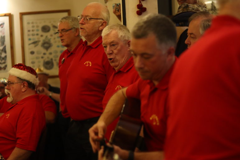 men singing in a pub