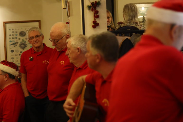 men in red polo shirts