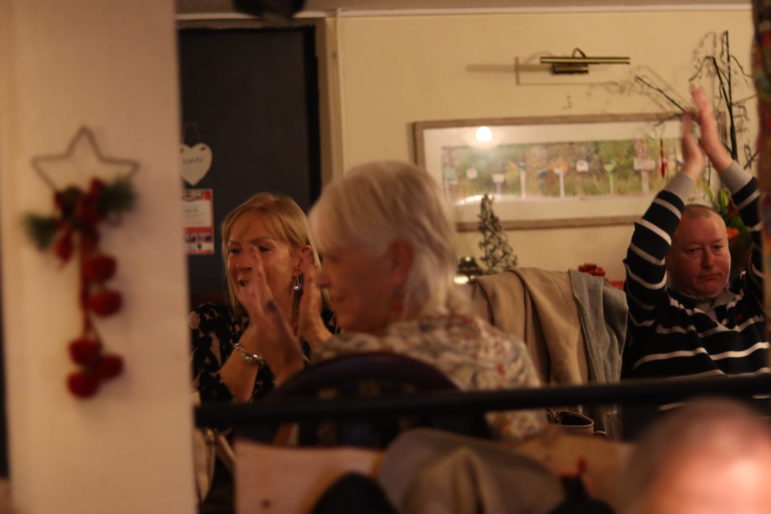 two women clapping their hands