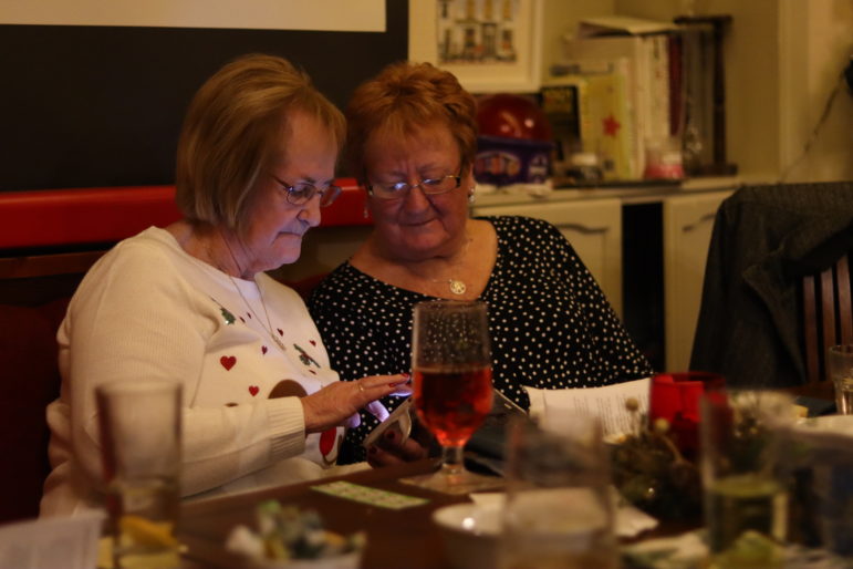 two women looking at a mobile phone