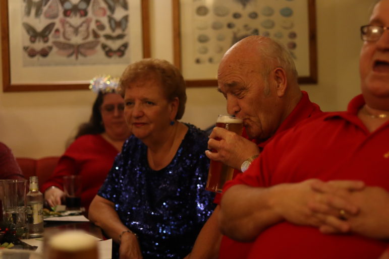 a man sipping a beer