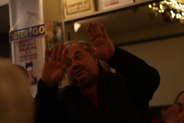 a man waving his hands in the air