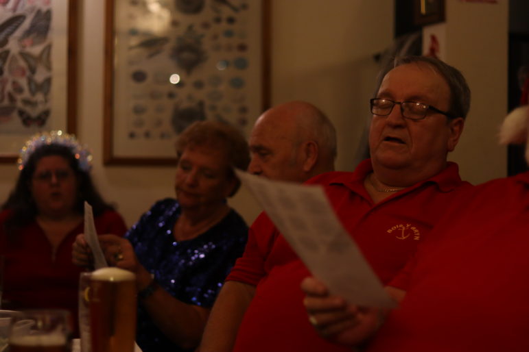 a man singing in a pub