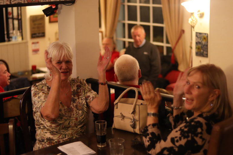 two women clapping their hands