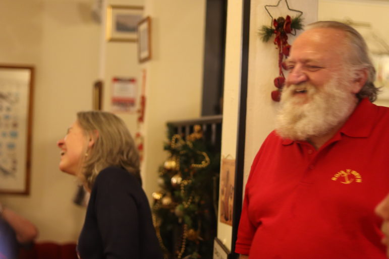 man and woman laughing in pub