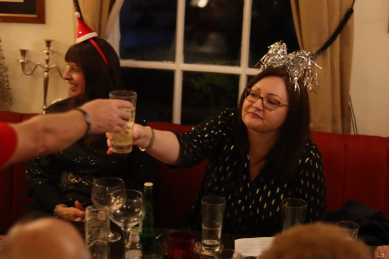 woman grabbing glass of drink