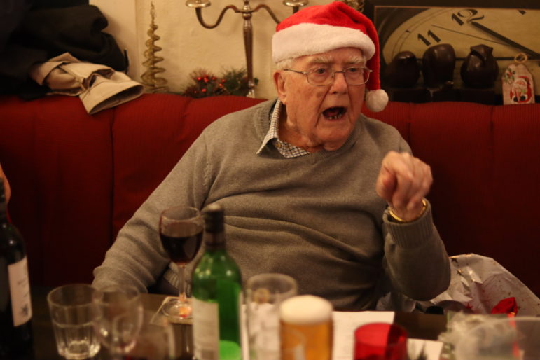 man in santa hat pointing finger