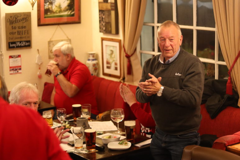 man stood up at pub table