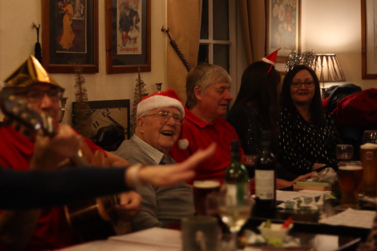 a man in santa hat singing