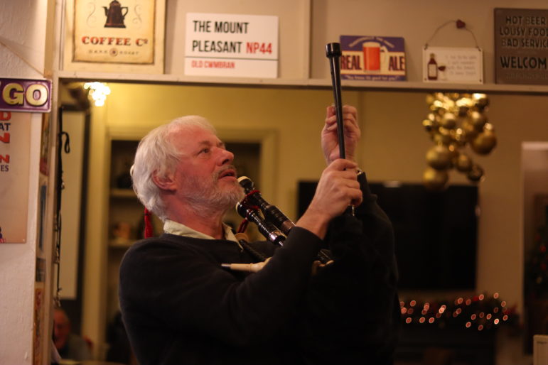 a bagpiper preparing to play