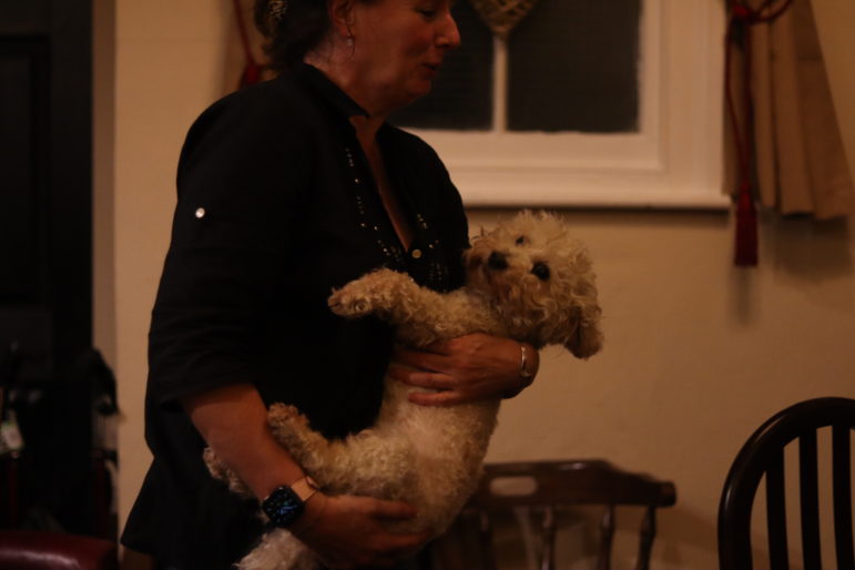 a woman holding a dog