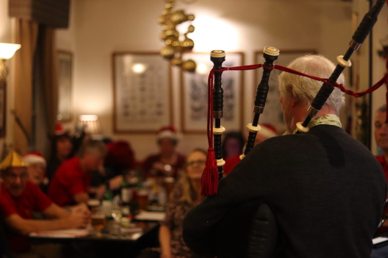 a bagpiper in a pub