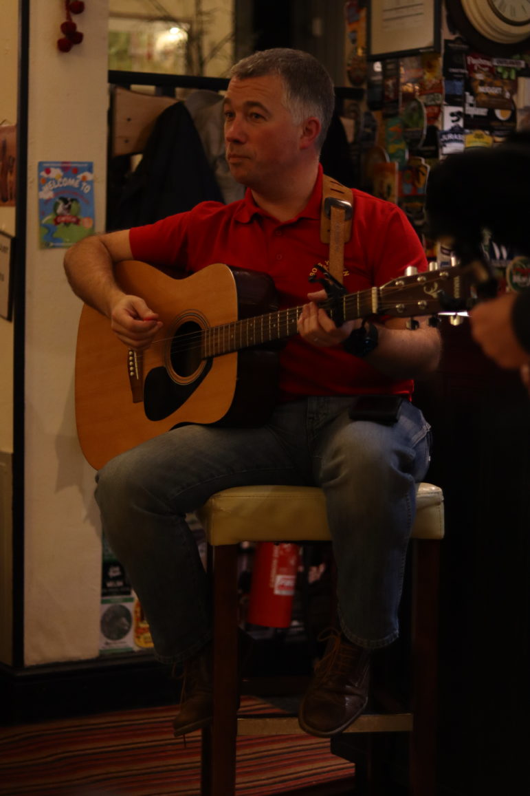 a man playing a guitar
