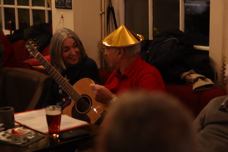 a man with guitar and a woman