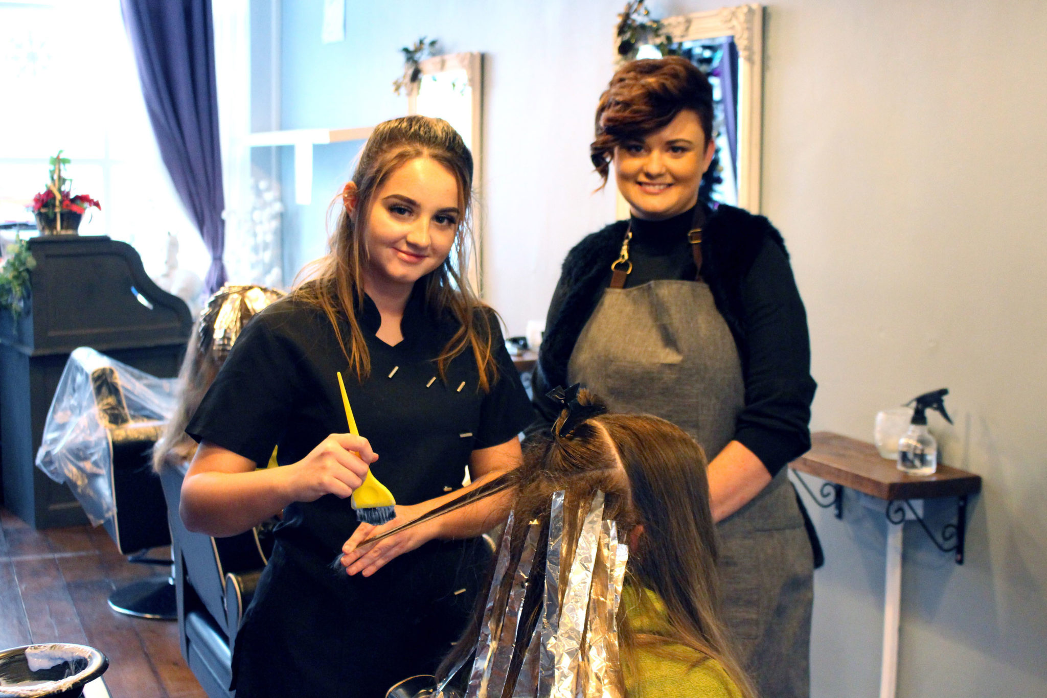 Jessica Davies supervising apprentice Caitlin Simmonds at work in the salon