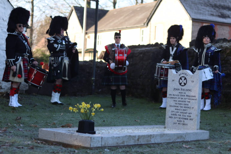 bagpipers at a grave