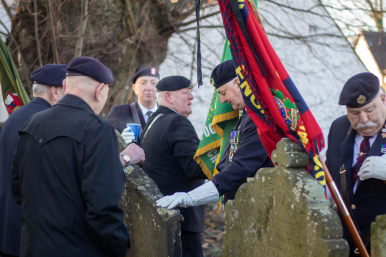 Service veterans in a graveyard