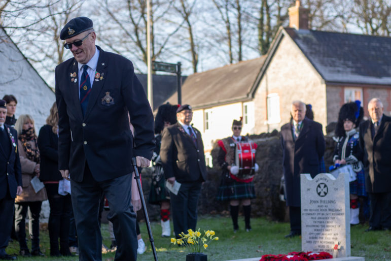 A former serviceman walking with a stick