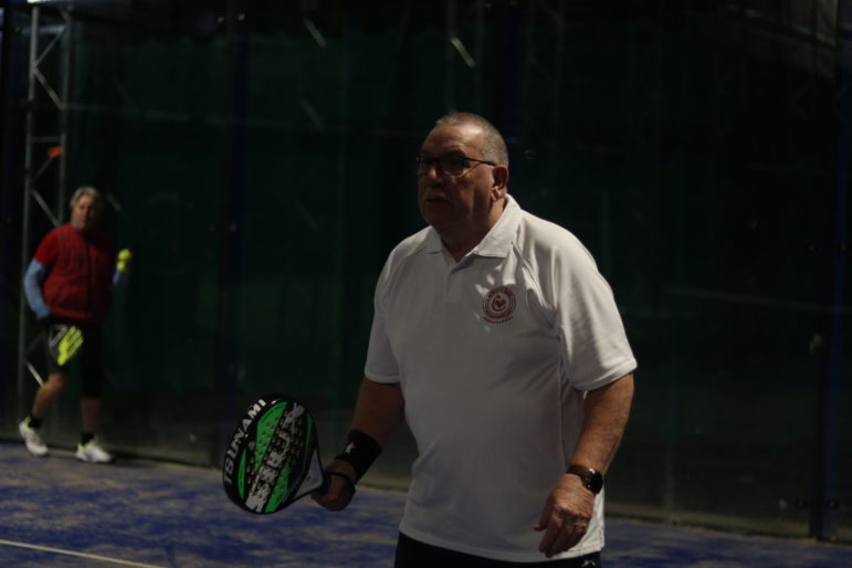 a man playing padel tennis