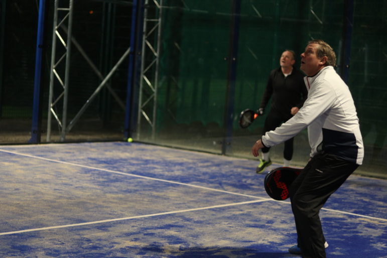 a man playing padel tennis