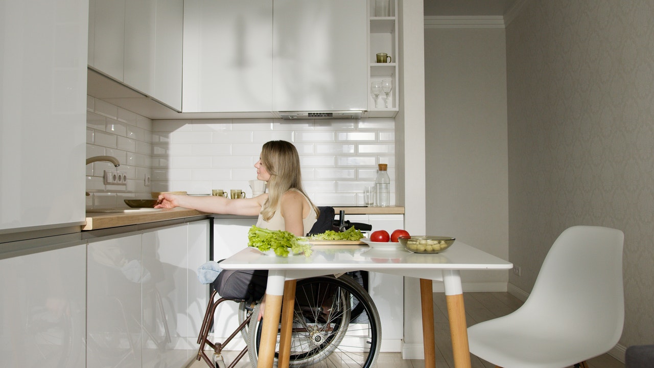 A Woman in wheelchair Cooking in the Kitchen