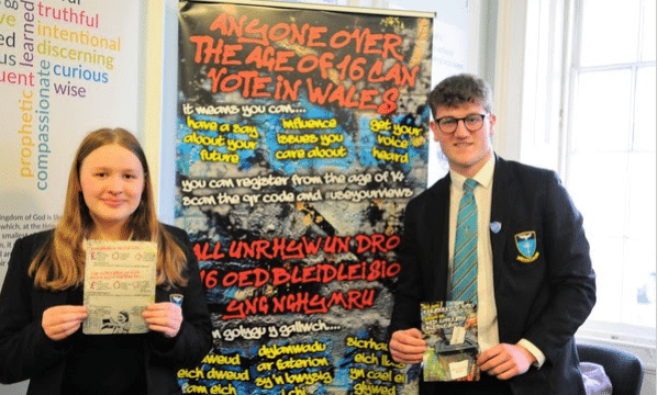 Two young people by voting stand